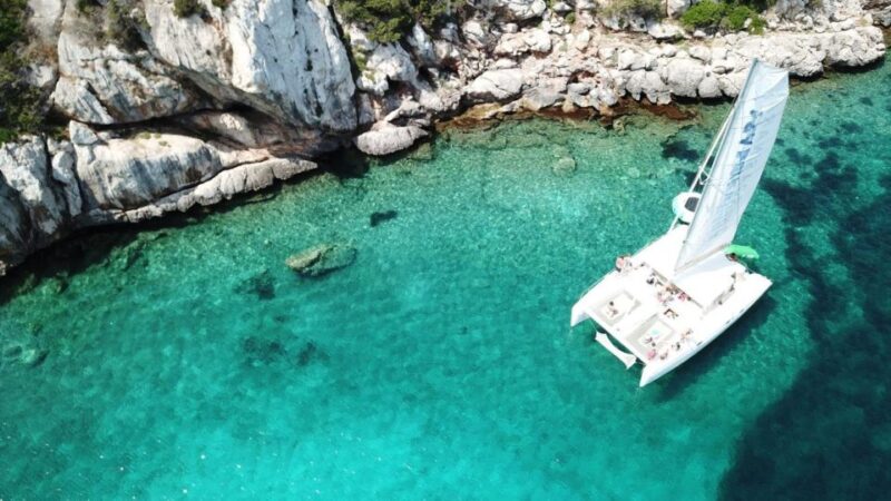 Alghero: Full Day on a Catamaran in Porto Conte Natural Park - Onboard Amenities and Experience