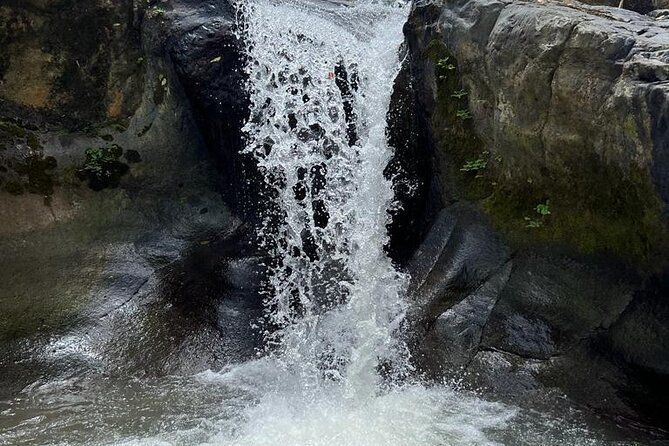 Casual One Day Tour: El Yunque, Waterslide, Beach, Dine, Shop - Splashing at Luquillo Beach