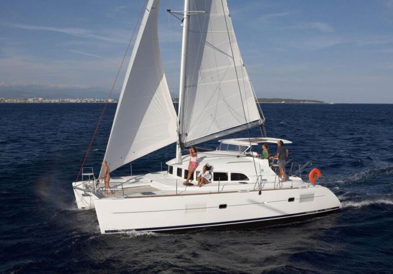 From Ornos: Mykonos Delos Catamaran Cruise With Meal & SUP - Crew and Inclusions