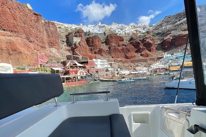 Half Day Premium Catamaran Cruise in Santorini Including Oia - Unique Features of the Tour