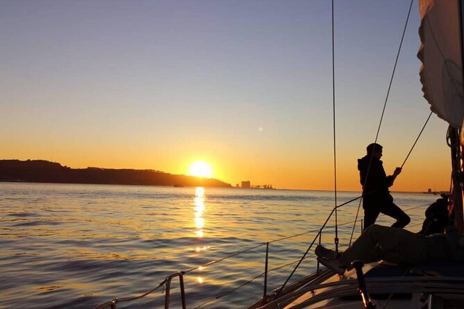 Sailboat Sunset Group Tour in Lisbon With Welcome Drink - Surreal Sunset Over the River