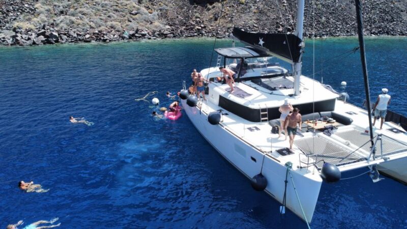 Santorini Catamaran Cruise With Swimming, Meal and Open Bar - Swimming Spots and Activities